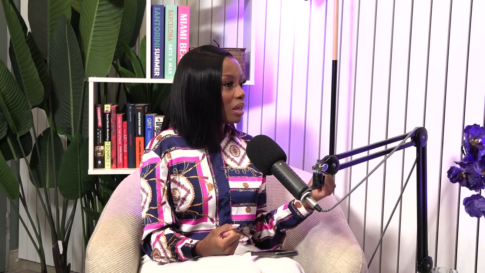 Khabo Mnguni speaking into a studio microphone during her podcast interview with Silindo Mabena